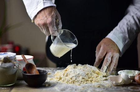 Closeup of the hands of an elderly woman kneading dough