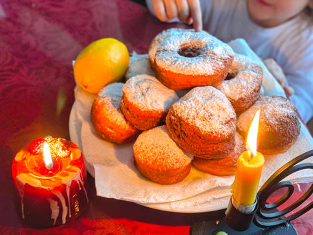 Children's birthday cake with powdered sugar and candles on the table.の写真素材