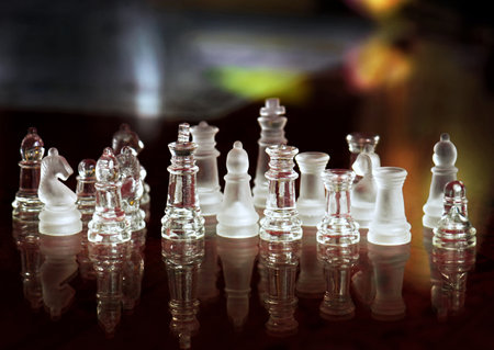 Chess pieces on a chessboard, shallow depth of field.