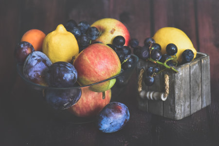 Fruits in a wooden box on a wooden background. Toned.の写真素材