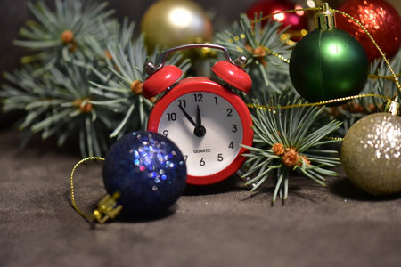Alarm clock and Christmas decorations on a dark background. New Yearの写真素材