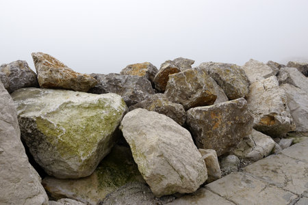 Rocky shore in a foggy day.