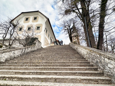 People on the stairs to the castle of Bled in Sloveniaの写真素材