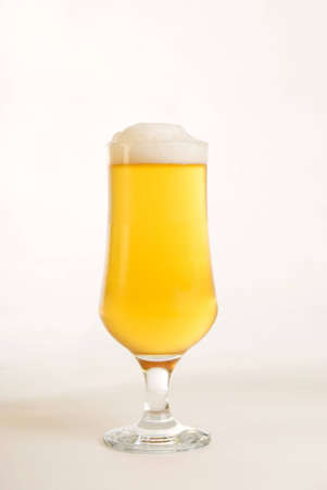 a vertical image of a pint glass of ice cold beerの写真素材