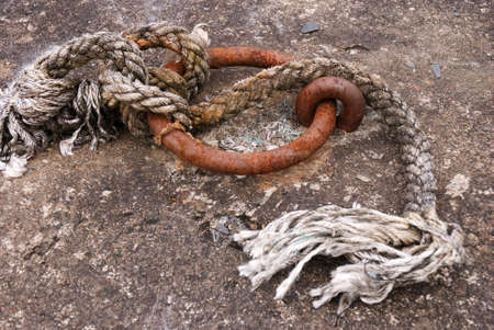 a horizontal image of an old rusting mooring ringの写真素材