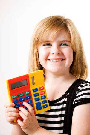 a vertical image of a young femal showing her answers on a brightly coloured calculatorの写真素材