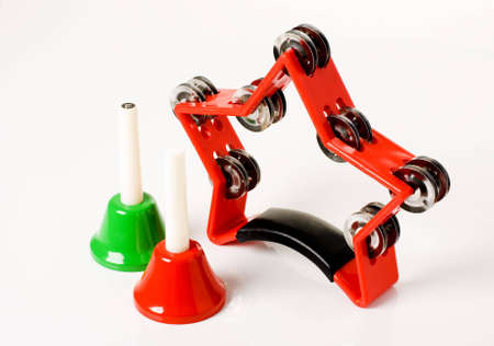 a horizontal image of a star shaped tambourine and two hand bellsの写真素材