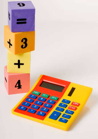 a vertical image of a brightly coloured calculator and counting blocks