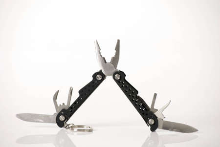 a horizontal image of a multitool open and showing attachments isolated on a white backgroundの写真素材