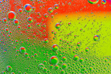 abstract macro of oil mixed with water on colorful gradient background and blurred styleの写真素材