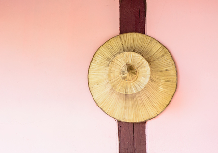Old palm hat for farmers hanging on the wall of homeの写真素材