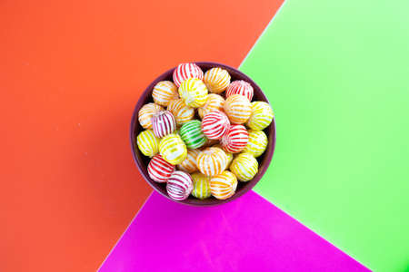 candy, colorful candies in bowl on colored backgroundの写真素材
