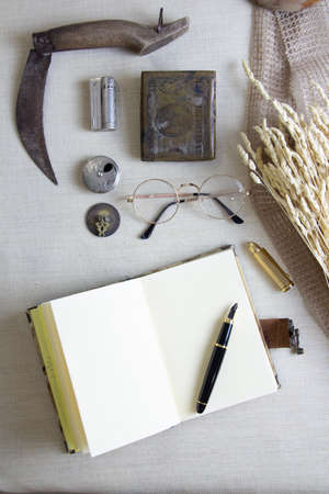 notebook, pen and vintage accessories on the table