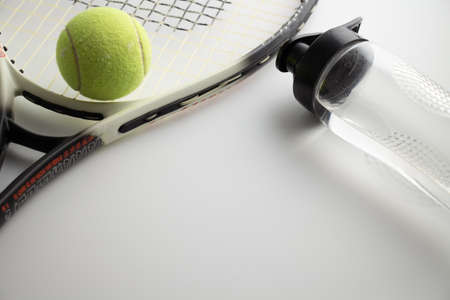 tennis racket, tennis ball and water bottle on a white backgroundの写真素材