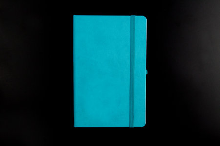 Turquoise notebook on black background
