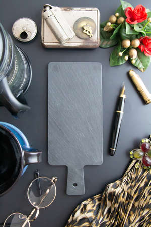 coffee in cup, french press, macarons, accessories on black backgroundの写真素材