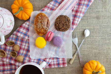 macarons, cookies, coffee, colorful accessories on the tableの写真素材