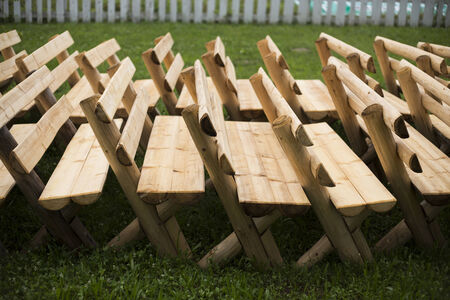 Newly made benches are awaiting painting process... they are stacked in a row.の写真素材