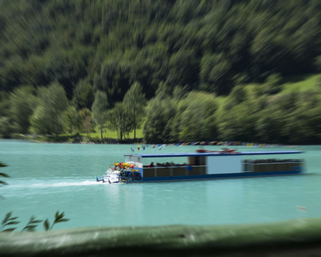 Little boat on a blue SoÄa river, Slovenia.. Blur effect.の写真素材