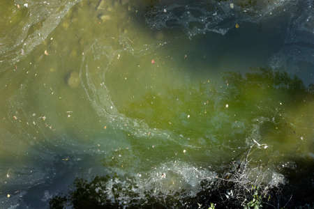 A photograph of polluted water, made from a bridge.の写真素材
