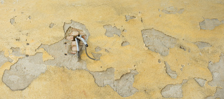 Air condition cables, hanging out of the wall.の写真素材