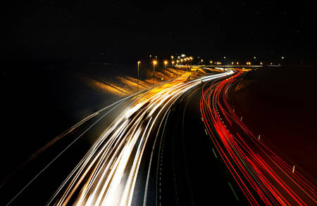 Highway light trails at night with traffic.