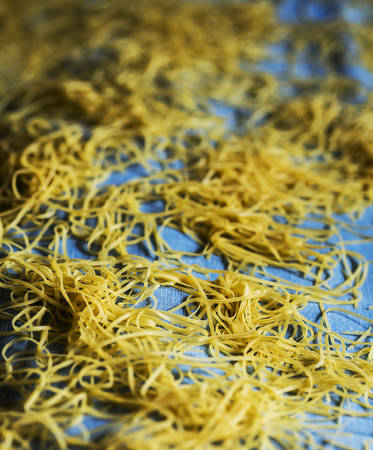 Home made noodles and placed on a textile to dry.の写真素材