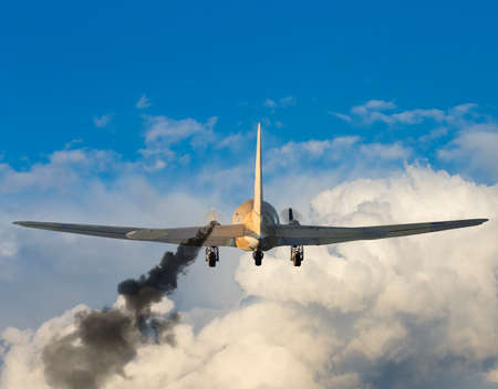 Damaged airplane with smoke coming from left engine.