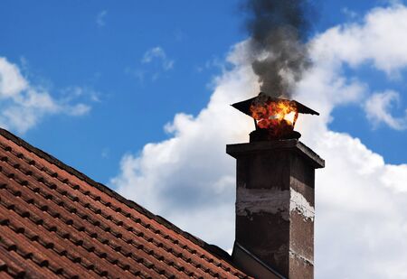 Chimmney on fire with smoke coming out.