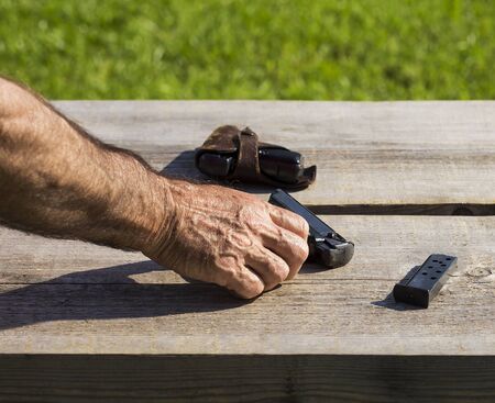 Old person is touching a gun.の写真素材
