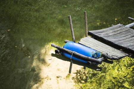 Floating plastic barrel dock in a river.の写真素材