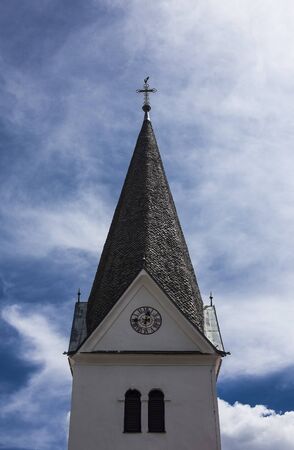 Christian church small tower with a cross and a clock.の写真素材