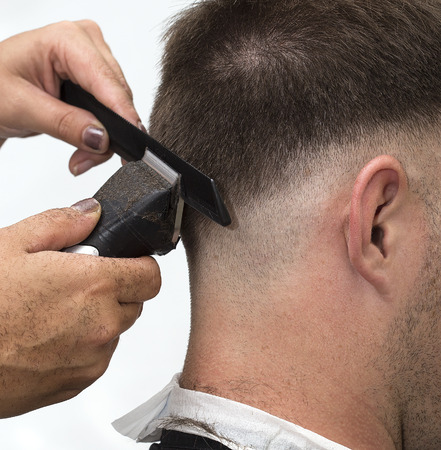 At the hairdresser getting a new male haircut.の写真素材