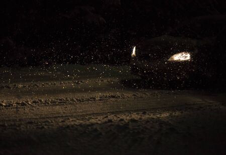 Car lights and falling snow.の写真素材