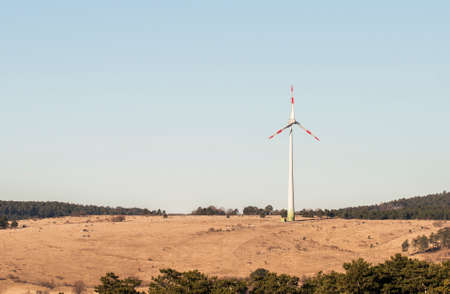 Wind turbine on a field producing energy.の写真素材