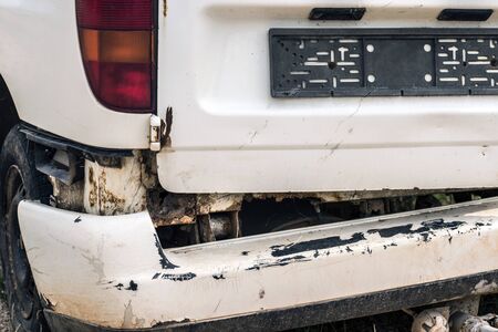 Old rusty and broken car bumper.