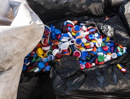 Pile of plastic bottle caps waiting to be recycled.