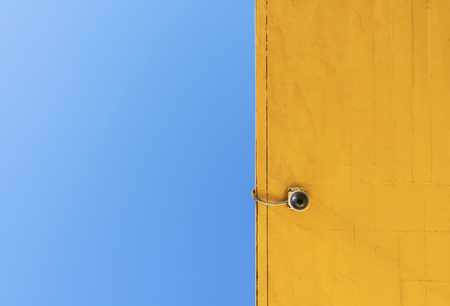 Security camera mounted on a wall.
