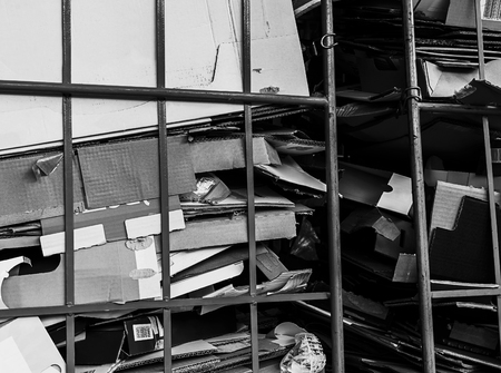 Used cardbord boxes stacked on a transport cart.