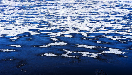 Partly frozen lake in winter time.