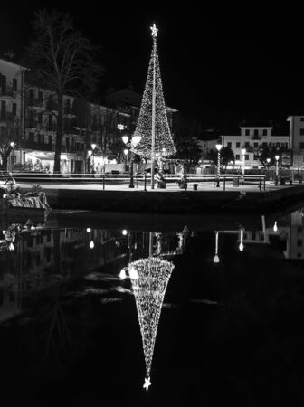 Grado, Italy, EU - January 2, 2019: Small christmass tree near a mediterranean sea canal.のeditorial素材