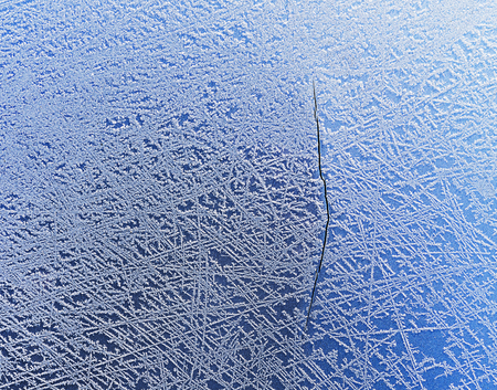 Frozen car hood with a big crack all over on metal surface.の写真素材