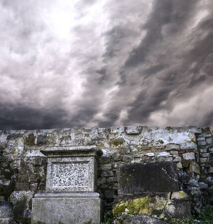 Gravestones with dramatic clouds scene behindの写真素材