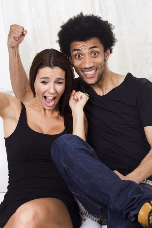Cheerful happy interracial couple at homeの写真素材
