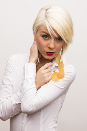 Beautiful sexy blonde woman on gray isolated backgroundの写真素材