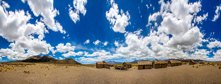 A panorama of a bolivian famming village on the altiplano under a big blue skyの写真素材