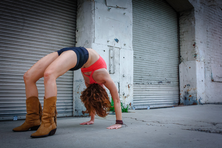 An urban Yogi meditates and practices outdoor yoga outside in the cityの写真素材