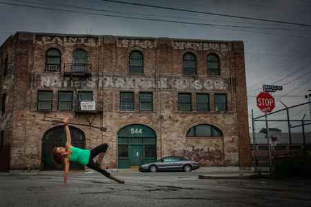 An urban Yogi meditates and practices yoga in the cityの写真素材