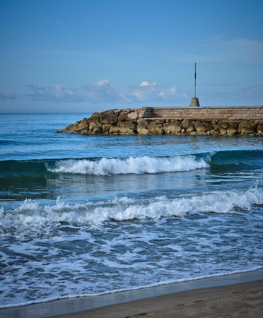 Beautiful seascape with breakwater, waves and blue skyの写真素材