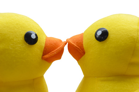 two yellow duck dolls kissingの写真素材